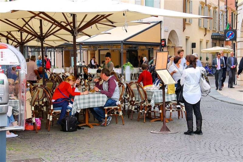 VERONA, ITALY - MAY 7, 2014: People are resting in outdoor cafe at the center Verona, Italy, stock photo