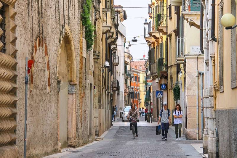 VERONA, ITALY - MAY 7, 2014: People on a narrow street in Verona, Italy, stock photo