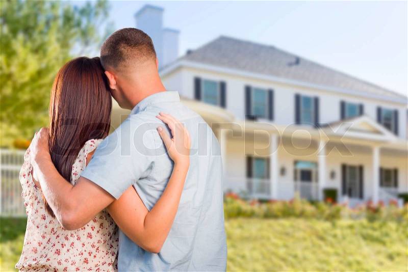 Affectionate Military Couple Looking at Nice New House, stock photo