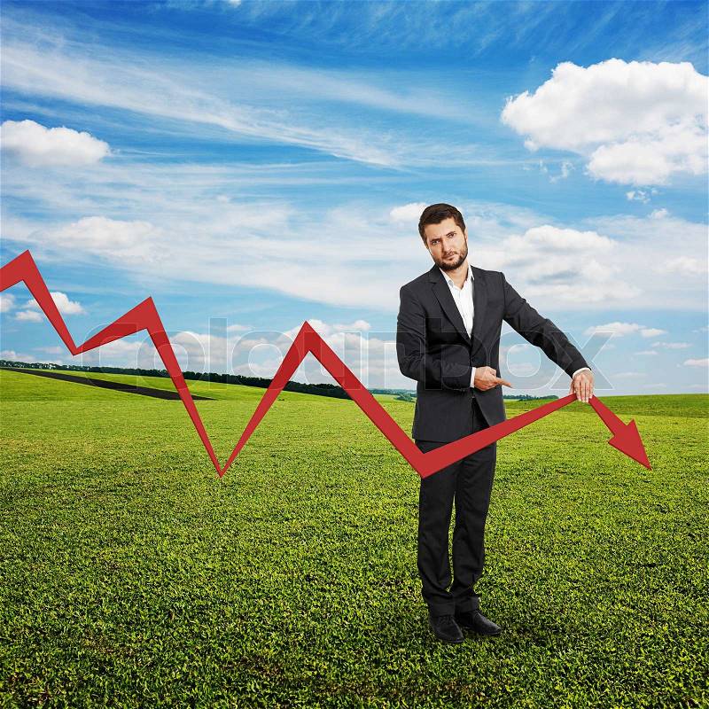 Sad broker holding and pointing at falling down graph. photo at outdoor, stock photo