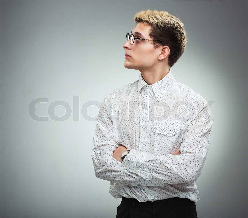 Young serious man in glasses in profile, stock photo