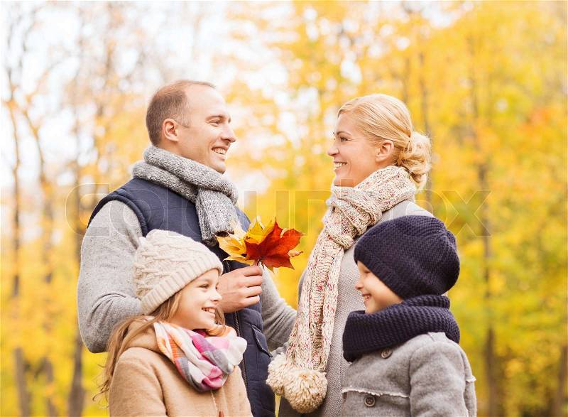 Family, childhood, season and people concept - happy family in autumn park, stock photo
