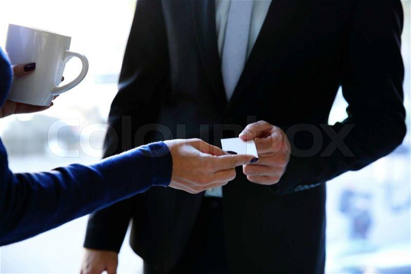 Concept shot of exchange business card between man and woman, stock photo