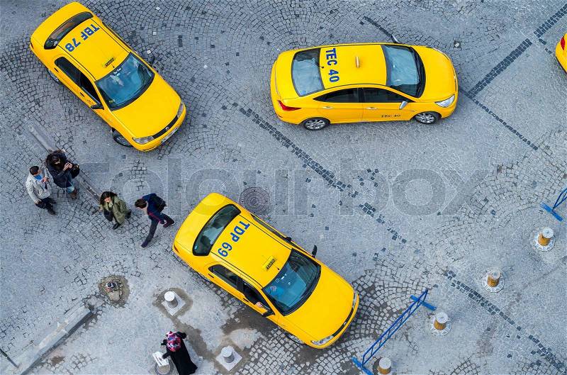 ISTANBUL, TURKEY - SEPTEMBER 13, 2014: Taxis await customers in a city square, aerial view. In Istanbul there are almost 20,000 taxis, most of them powered by clean LPG propane gas, stock photo