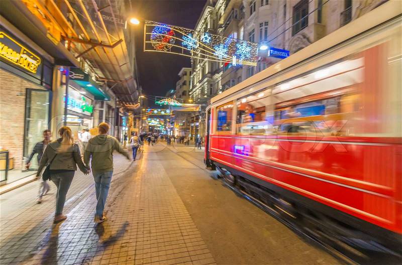 ISTANBUL, TURKEY - SEPTEMBER 13: Old tramway speeds up in Istiklal Caddesi, blurred night scene, September 13, 2014 in Istanbul, Turkey. Istiklal is the most crowded street in Istanbul, stock photo