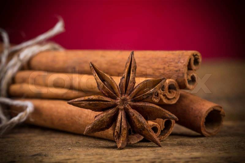 Close up of cinnamon sticks and star anise on rustic wood background, stock photo