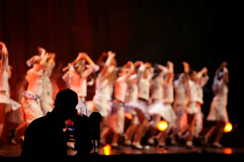 Cameraman and ballet spectacle with dancers on stage, stock photo