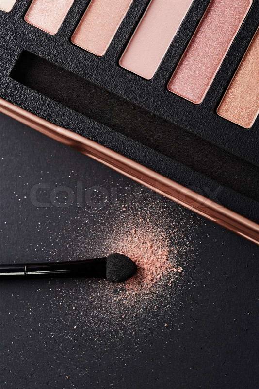 Brush with make up powder on black background, stock photo