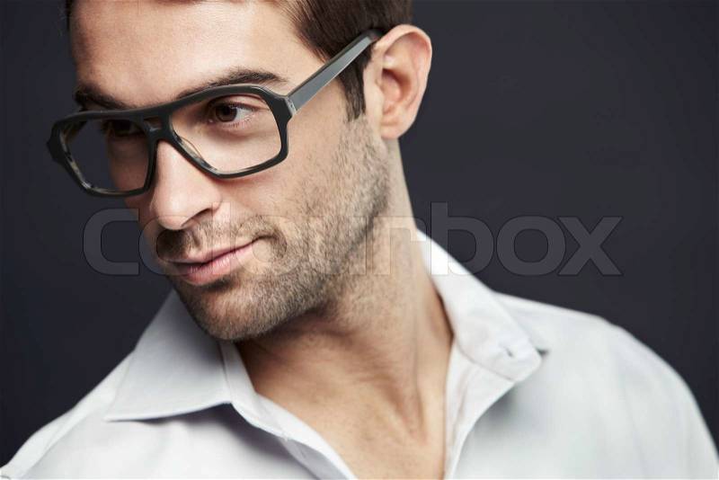 Mid adult man wearing glasses, studio shot, stock photo