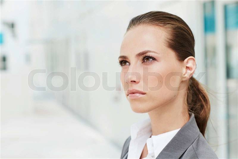 Young businesswoman looking away, close up, stock photo
