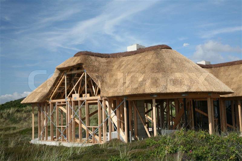 Construction of half timbered traditional house with thatched traditional roof, stock photo