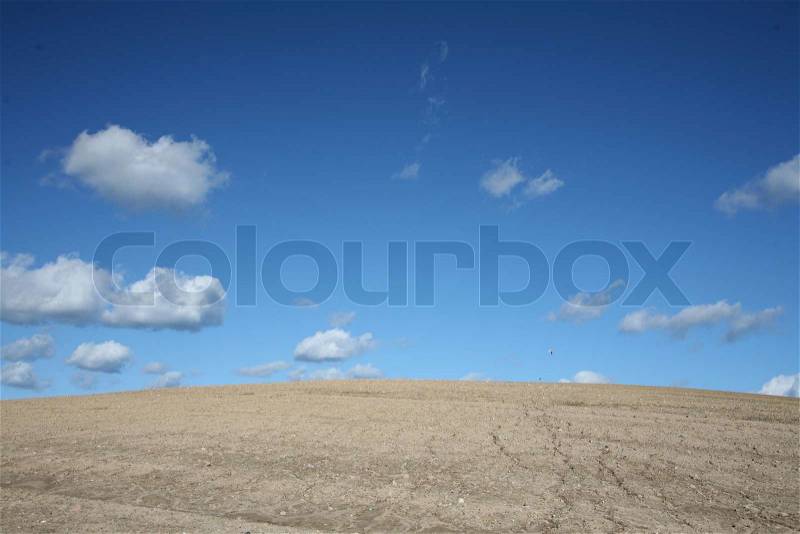 Desert under summer sky with nice cloud formation, stock photo