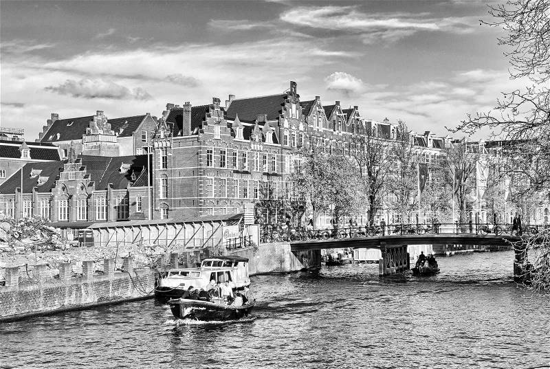 Channels of Amsterdam. Typical Amsterdam architecture. Urban space in the spring, stock photo
