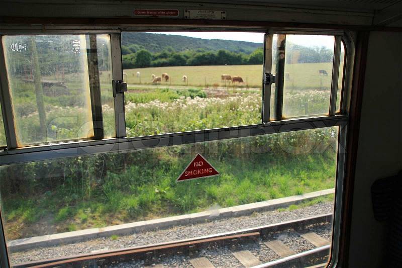 Detail, open window, from the coupé of an ancient train wait for departure in summertime, stock photo