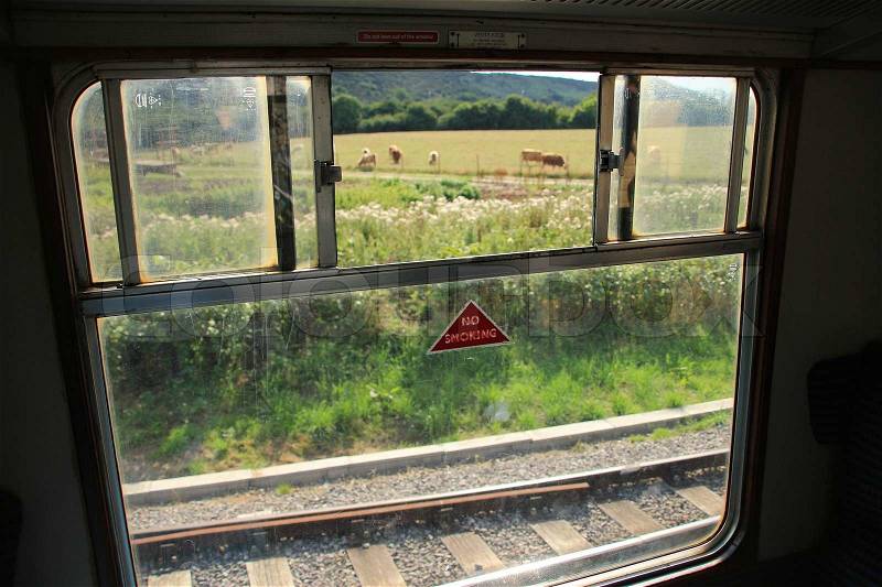 Detail, open window, from the coupé of an ancient train wait for departure in summertime, stock photo