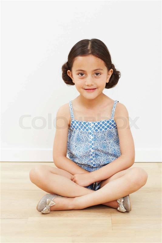 Young girl sitting on floor, portrait, stock photo