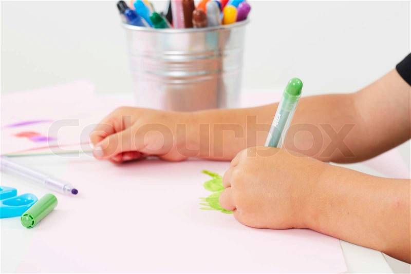 Young boy drawing at table, close up, stock photo