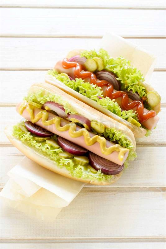 Hot dogs with mustard and ketchup from above on wooden background,selectve focus , stock photo