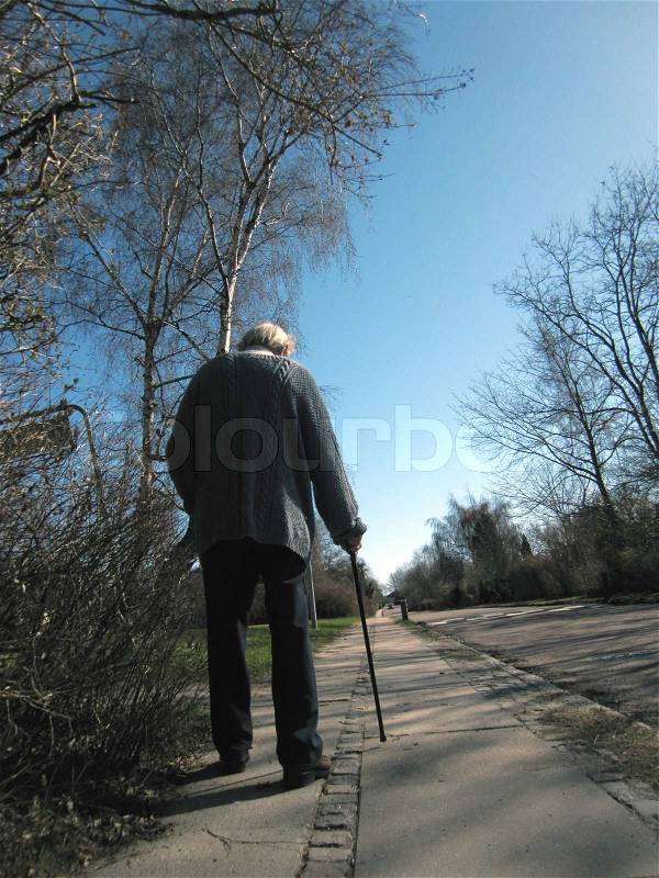 Old man with walking stick, stock photo