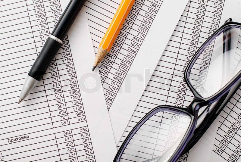 Close up Eyeglasses, Black Ballpoint Pen and Orange Pencil on Top of Business Reports with Number Prints, stock photo