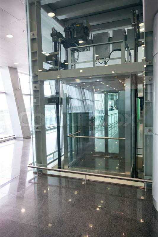 Modern glass elevator for disabled people at international airport, stock photo
