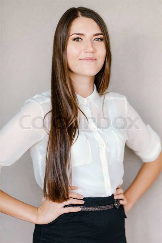 Professional woman with hands on hips , stock photo