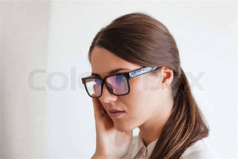 Serious young woman wearing cool glasses, stock photo