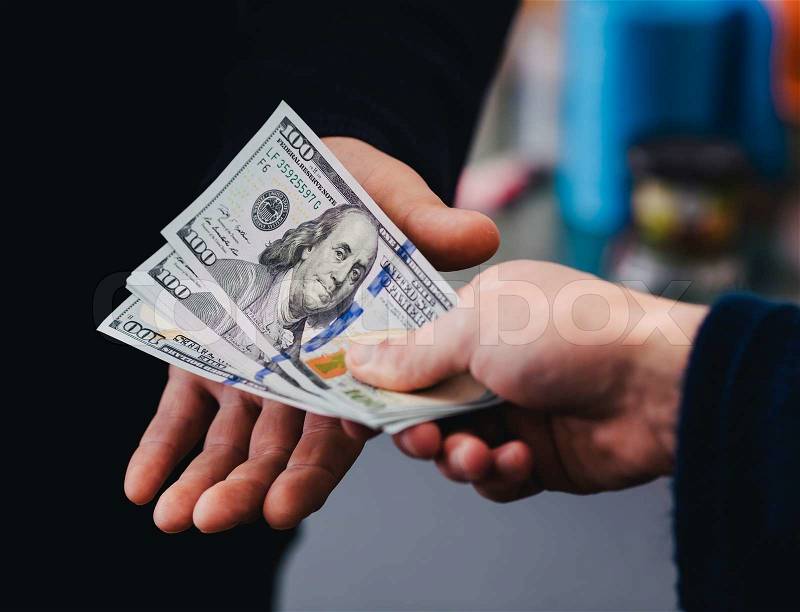 Transfer of money from hand to hand, stock photo