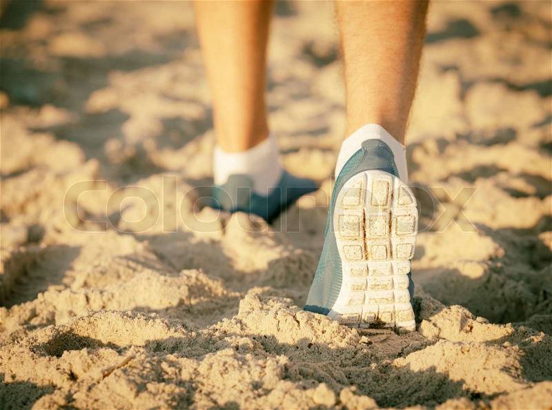 runner running on a empty beach, stock photo