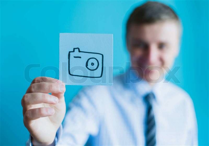 Paper painted with a camera in hand, stock photo