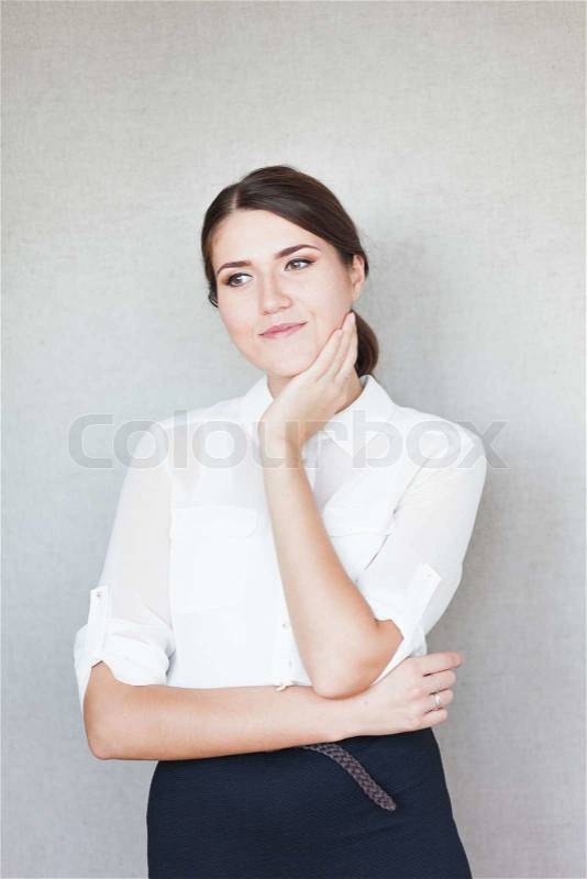 Beautiful woman smiling and thinking with hands folded, stock photo