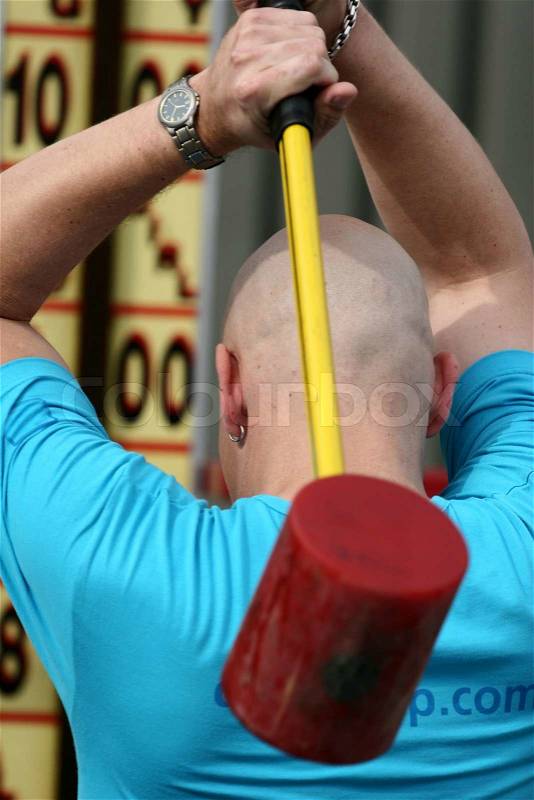 Close up of people at sport, bold man with hammer, stock photo