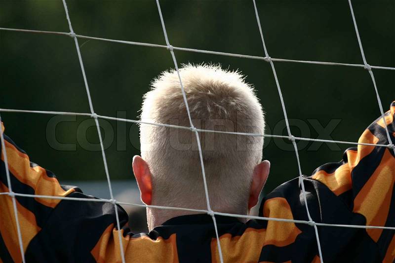 Close up of people at sport, silhouette of a goalkeeper shot from behind, stock photo