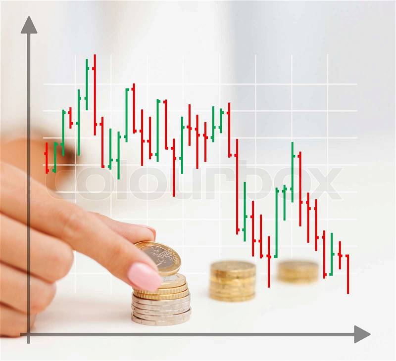 Business, finances, crisis, people and money saving concept - close up of graph and female hand putting euro coins into columns in office, stock photo