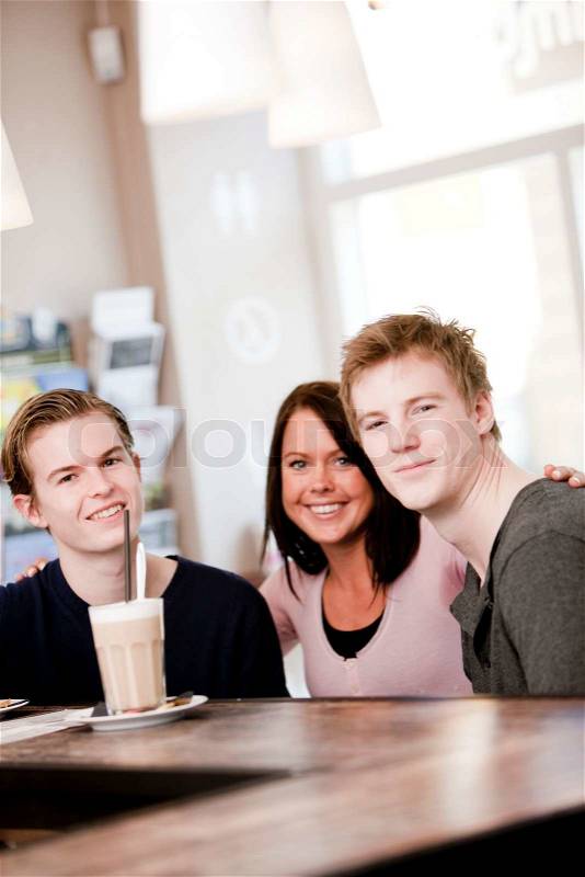 A group of friends enjoying cafe latte in a cafe/restaurant, stock photo