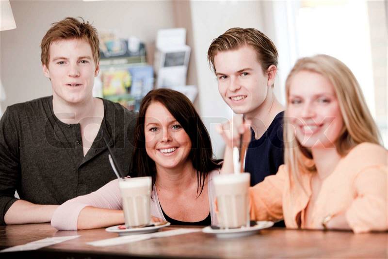 Two young caucasian couples on a double date drinking cafe latte, stock photo