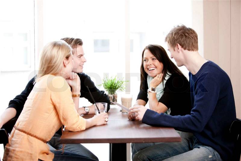 Two young caucasian couples on a double date in a restaurant, stock photo