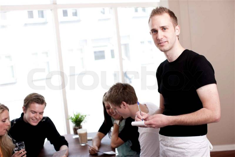 A restaurant waiter ready to take orders from customers, stock photo