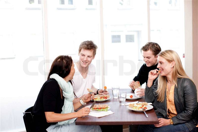 A group of young Europeans enjoying lunch in a cafe/restaurant, stock photo