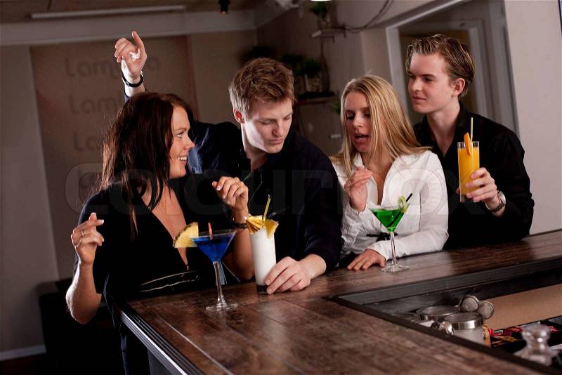 A group of young Europeans enjoying drinks in a bar, stock photo