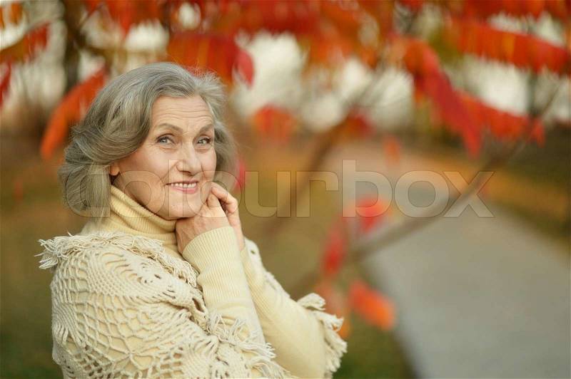 Portrait of senior woman in the park in autumn, stock photo
