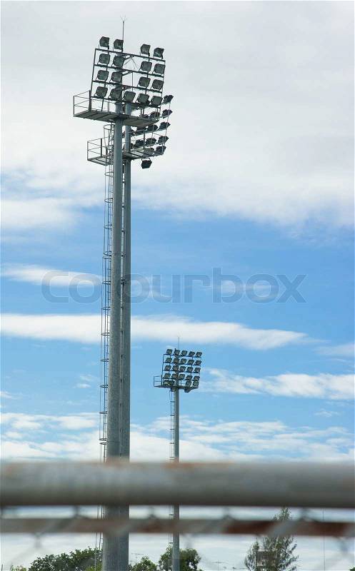 Stadium sports lighting against on blue sky background, stock photo