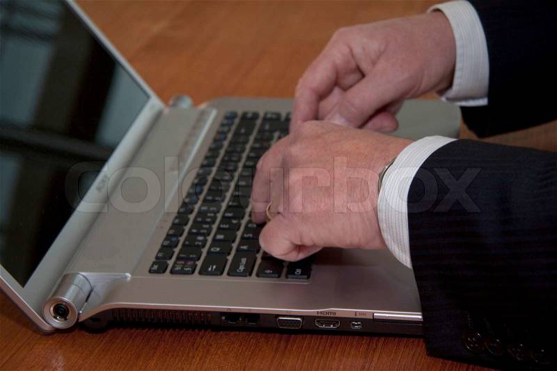 Business man typing on laptop computer close up of hands, stock photo
