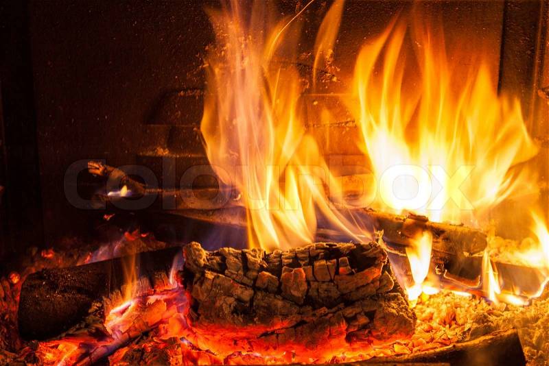 Burning firewood in the fireplace close up, stock photo