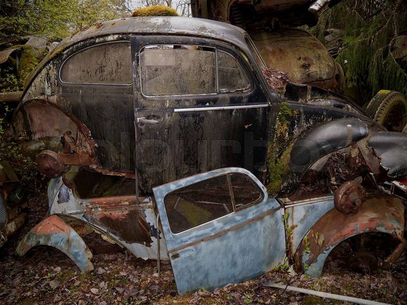 Heap of old cars left in the nature near the Norwegian border - Sweden. From the series scrap in the wood, stock photo