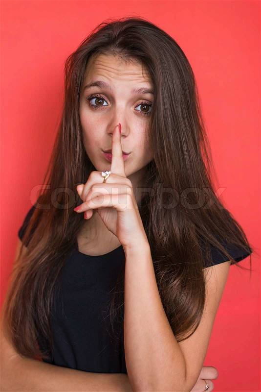 Secret woman. Female showing hand silence sign , stock photo