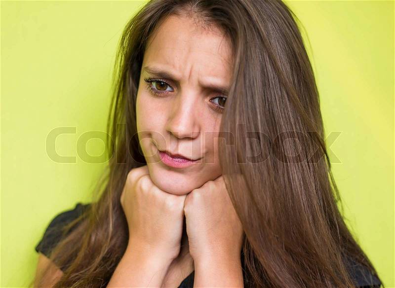 Woman with headache holding head with hands and have grimace on his face, stock photo