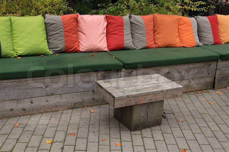 Many pillows in different colours on the bank outdoors in fall, stock photo