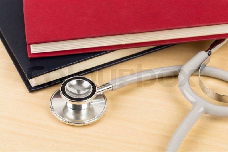 Stethoscope and textbook concept for medical education, stock photo