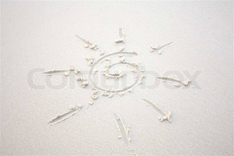 Sand background with the sun symbol, stock photo